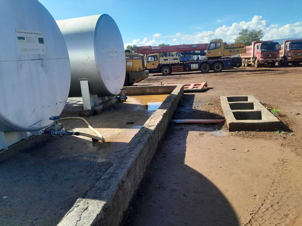 Above ground storage tanks being installed with cranes
